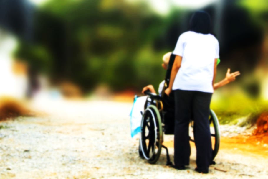 Woman pushing a senior in a wheel chair