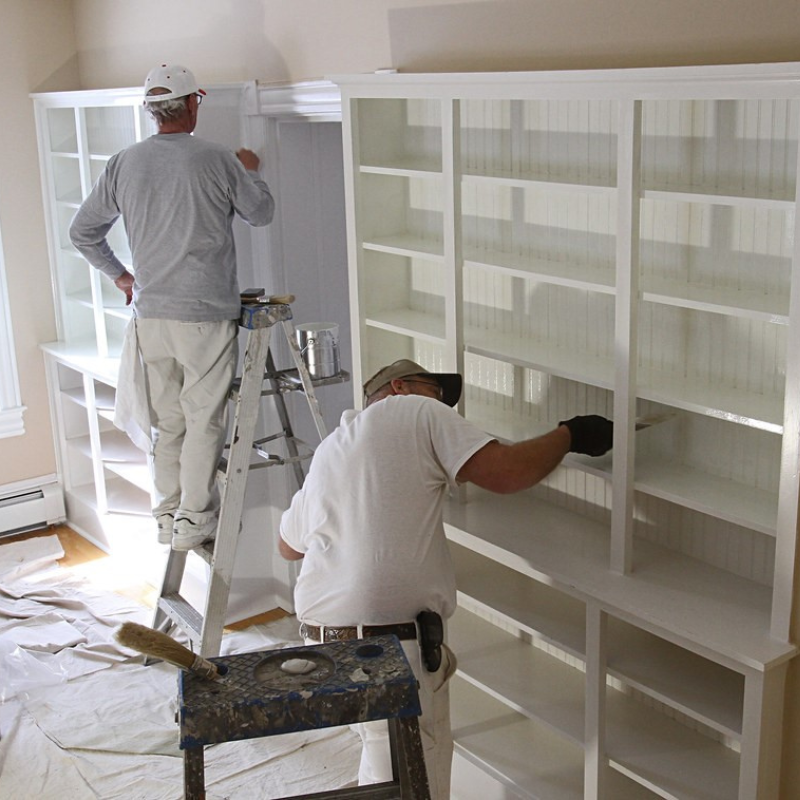 Painters, painting a shelf in a home